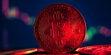 Coins with bitcoin symbol on red light and crypto stocks chart b